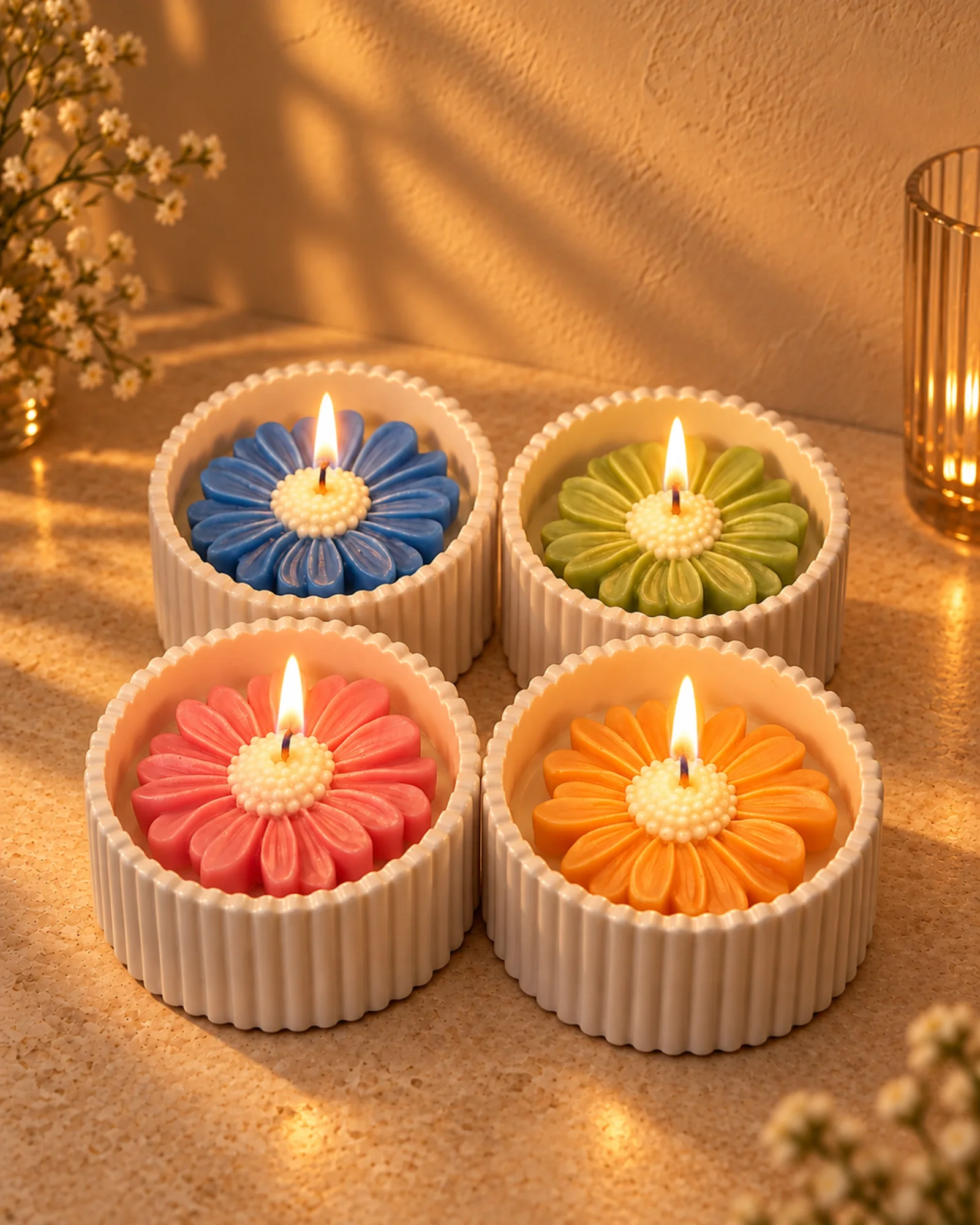 Four British rose-scented flower candles from the Daisy Glow Set lit in a warm interior