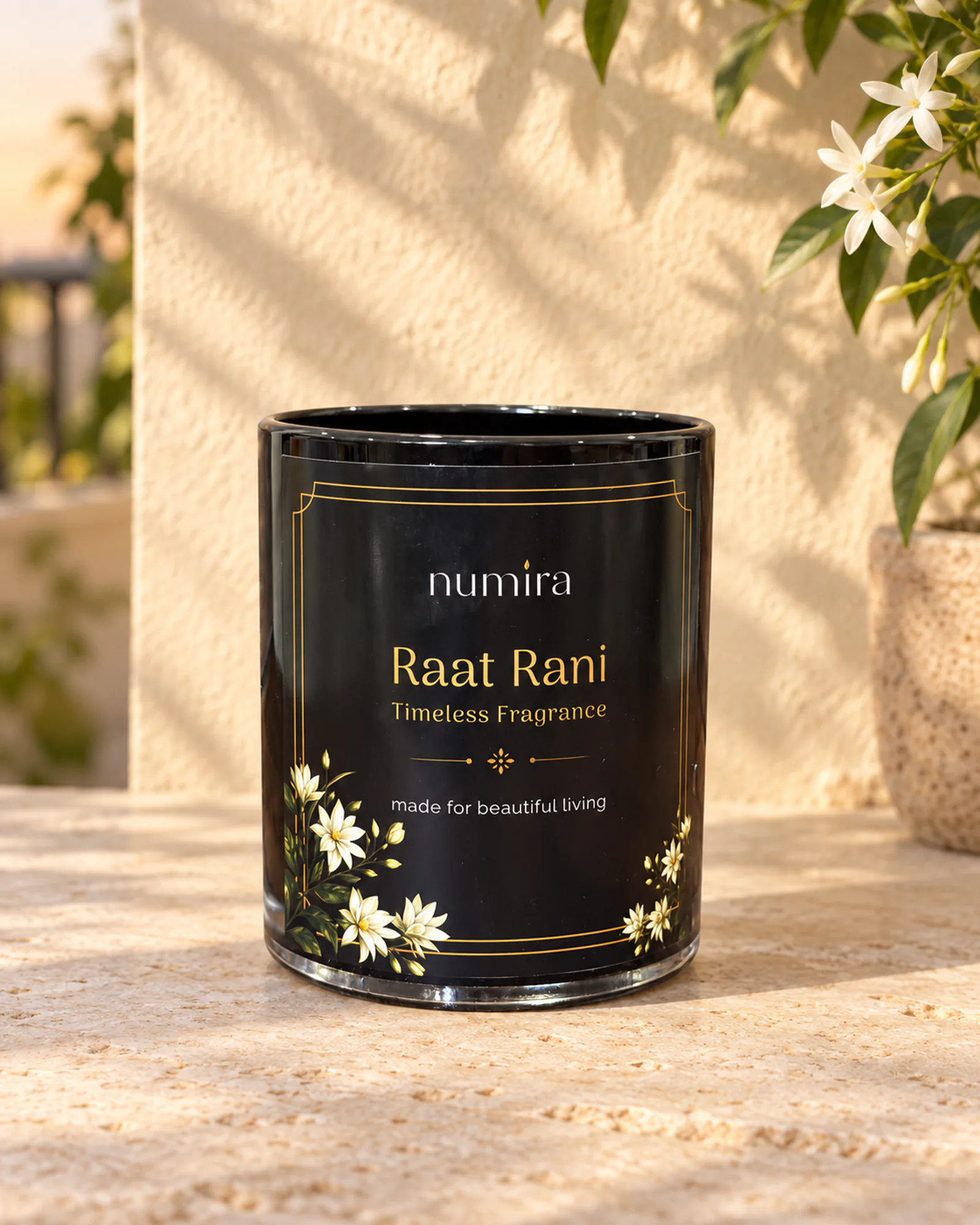 Raat Rani scented candle in a glossy black glass jar